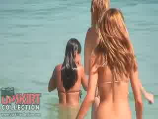 The cutie dolls in seksual bikinis are playing with the waves and getting spied on